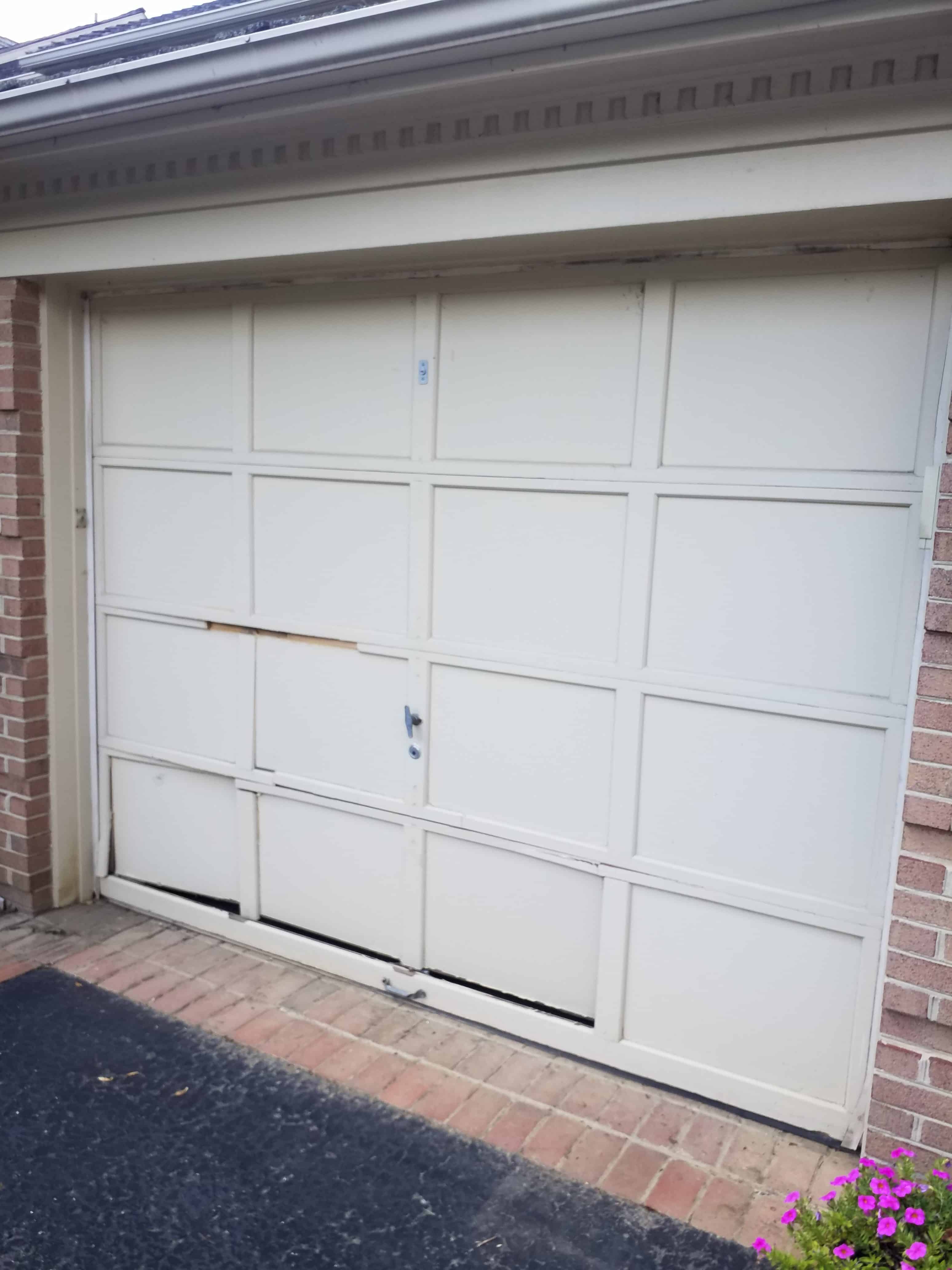 wood garage door damaged